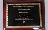 A plaque from the Western Psychological Association presenting the Meritorious Service Reward to Kimberly Barchard in April 2018.